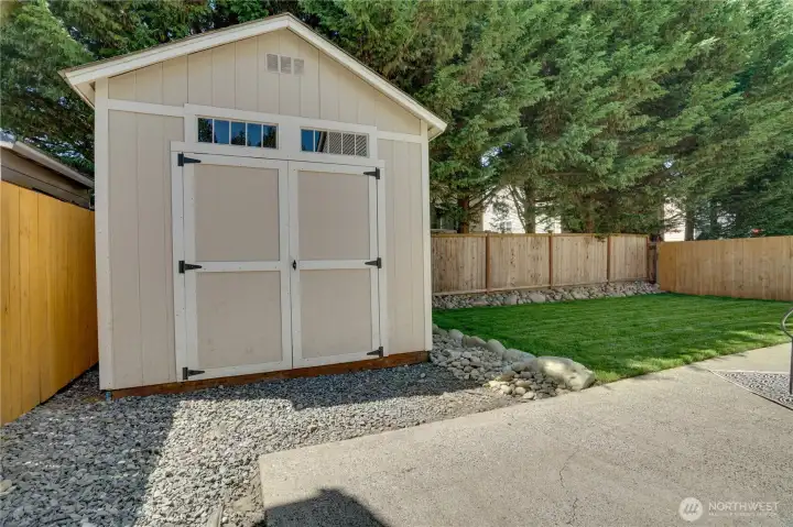 The shed can hold tools, toys and more! Note the stylish new fence surrounding this backyard!
