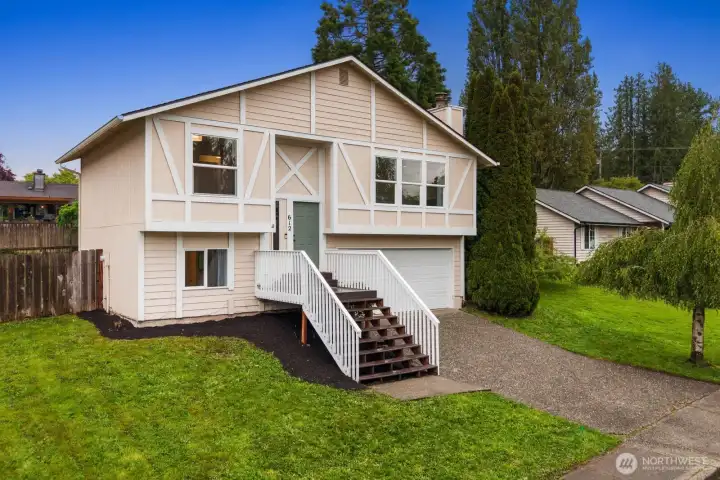 Elevated entry, landscaped yard, large driveway, split level home, curb appeal, quiet neighborhood
