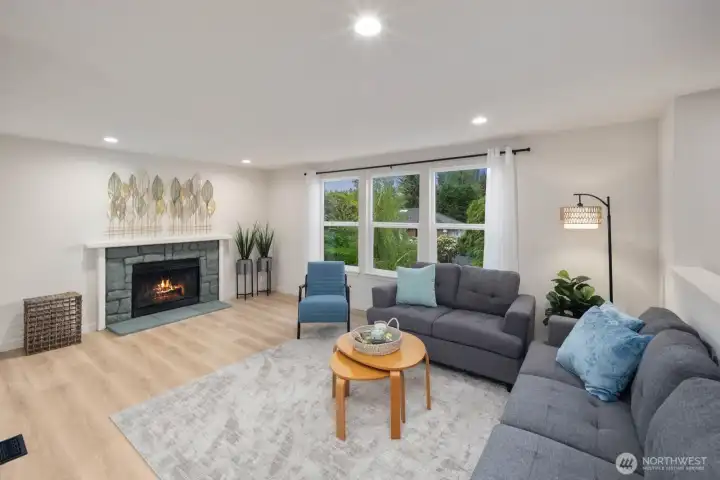 Bright living room with large windows, fireplace, and open layout in Snohomish near Blackmans Lake.