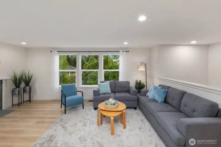 Open living room with large windows, natural light, and comfortable layout in Snohomish near Blackmans Lake.