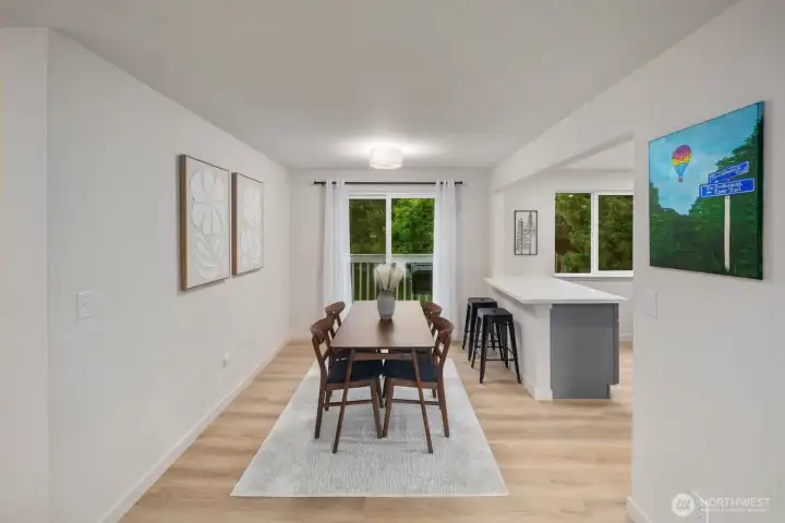 Dining area with deck access, breakfast bar, and open flow to kitchen.