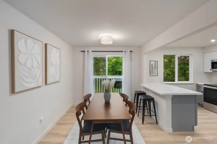 Dining area with breakfast bar seating, deck access, and open connection to kitchen.