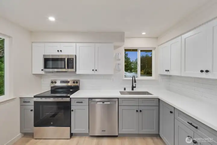 Bright kitchen with shaker cabinets, stainless appliances, and generous counter space.
