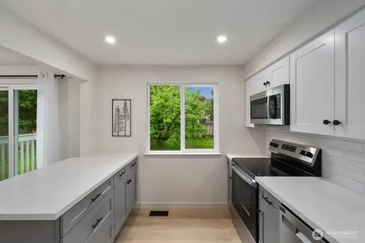 Functional kitchen layout with generous counter space, modern cabinetry, and natural light.