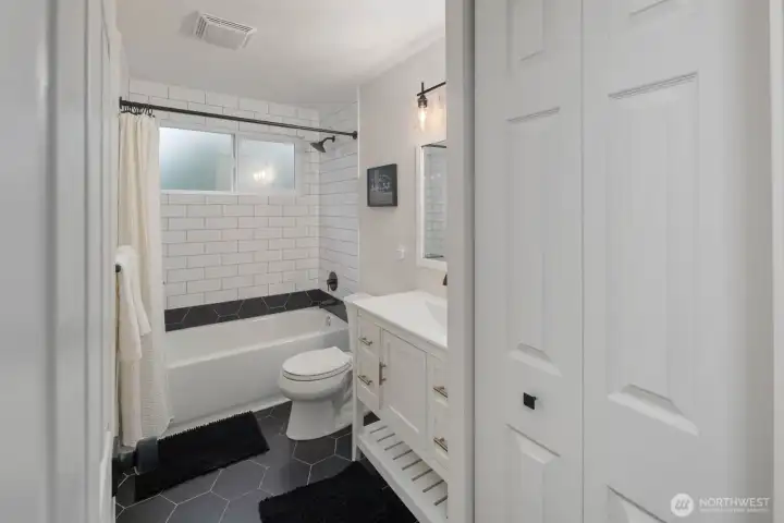 Bathroom with subway tile surround, modern vanity, and clean finishes.