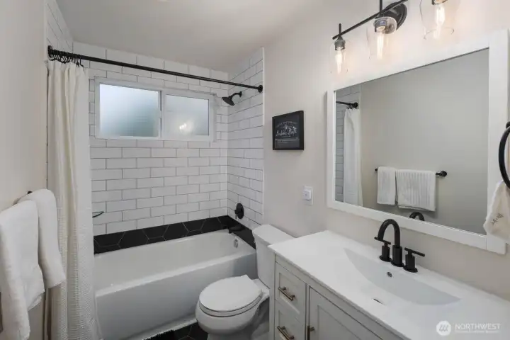 Full bathroom with tub/shower combo and efficient, well-laid-out space.