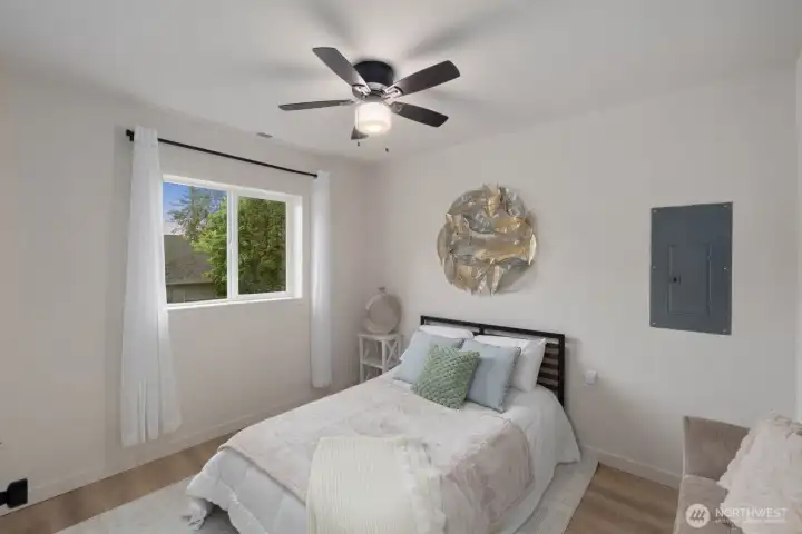 Private lower-level bedroom with en-suite bath and flexible space for guests or home office.