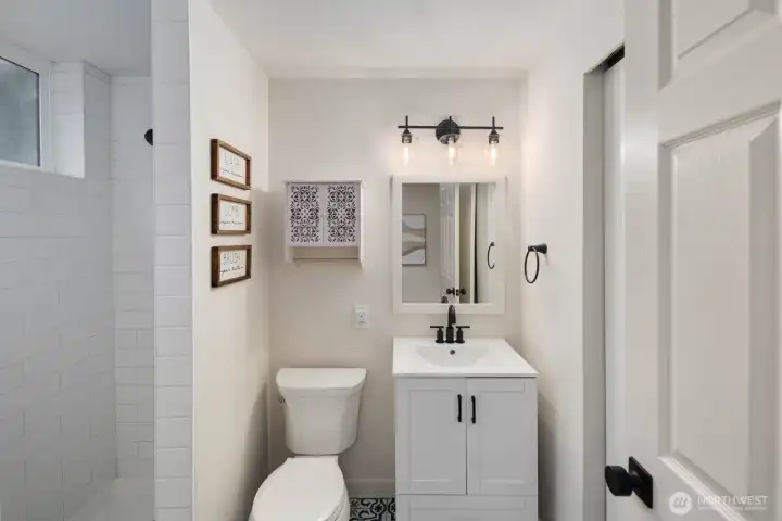 Lower-level bathroom with walk-in shower and clean, functional layout.