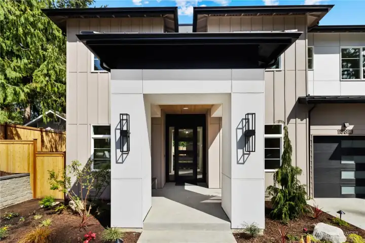 Dramatic entrywal with large covered front patio, plenty of room for a bench between the left column and house. Fully fenced yard and professionally landscaped yard with low-voltage lighting, and irrigation.