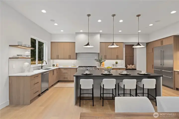 Expansive island with seating for four, pendant iights plus LED accents.