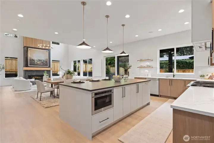 Tons of storage in this home with upgraded pull-out shelves inside several of the cabinets. The island seats four comfortably and is topped with a gorgeous soapstone slab.