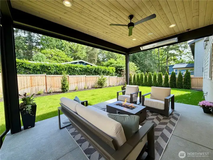 A wide sliding glass door leads to the large covered outdoor patio.Two ceiling heaters, ceiling fan, prewired for sound, dedicated gas BBQ line as well as a gas line that can be used for a fire table. Tall Arborvitae hedge was added for additional privacy. Long step in between the two pillars allows you to walk right out to the grassy backyard for fun summertime play.