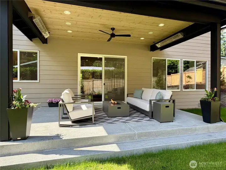 Fantastic, oversized covered patio for summertime BBQ's and gatherings with friends and family. Two ceiling heaters, prewired for speakers, ceiling fan, two dedicated gas connections (one for BBQ and one for a fire table) with steps down to the oversized level backyard.