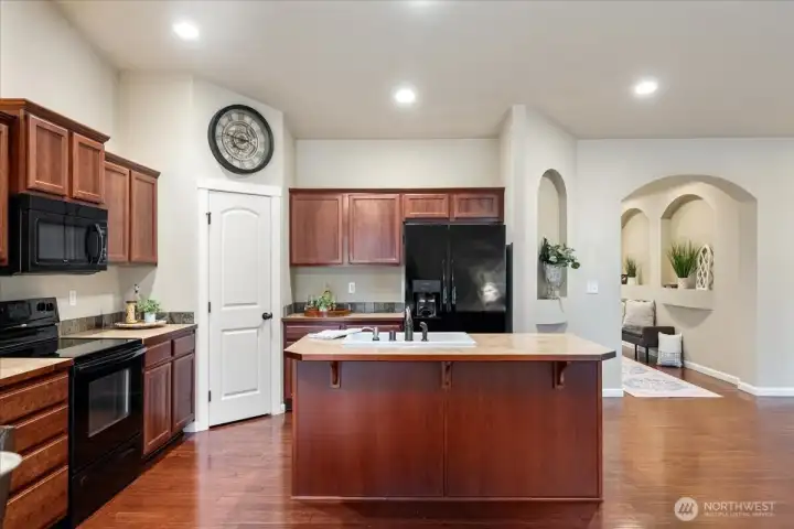 Open kitchen with pantry and island for dining.