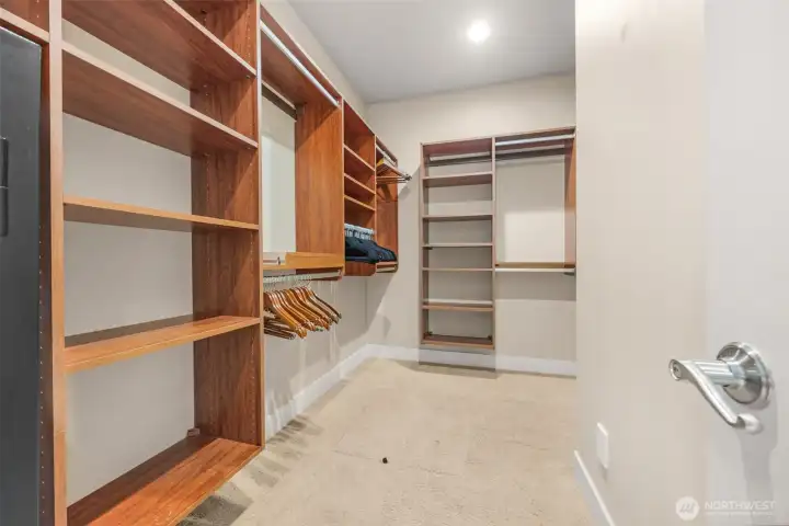 Primary suite walk-in closet. Primary suite walk-in closet.
