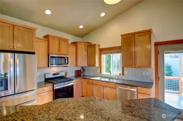 Granite counters, gas stove and stainless steel appliances