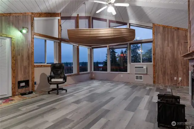 Main living area with huge windows showing off the water/mountain view.