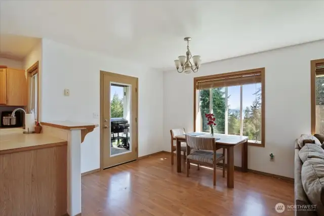 Dining area is open to living space, access to deck for BBQ'ing or enjoying outdoor space.