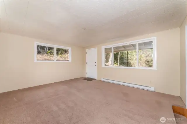Large and bright living room with covered deck off the back of the home