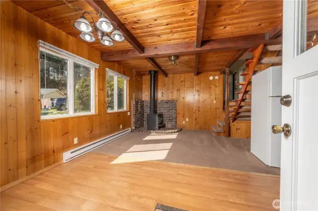 Main entrance into the kitchen and dining area with cozy wood burning fireplace