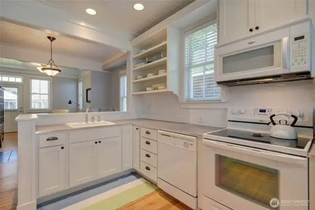 The kitchen is generous and charming with open shelving and all the modern conveniences.