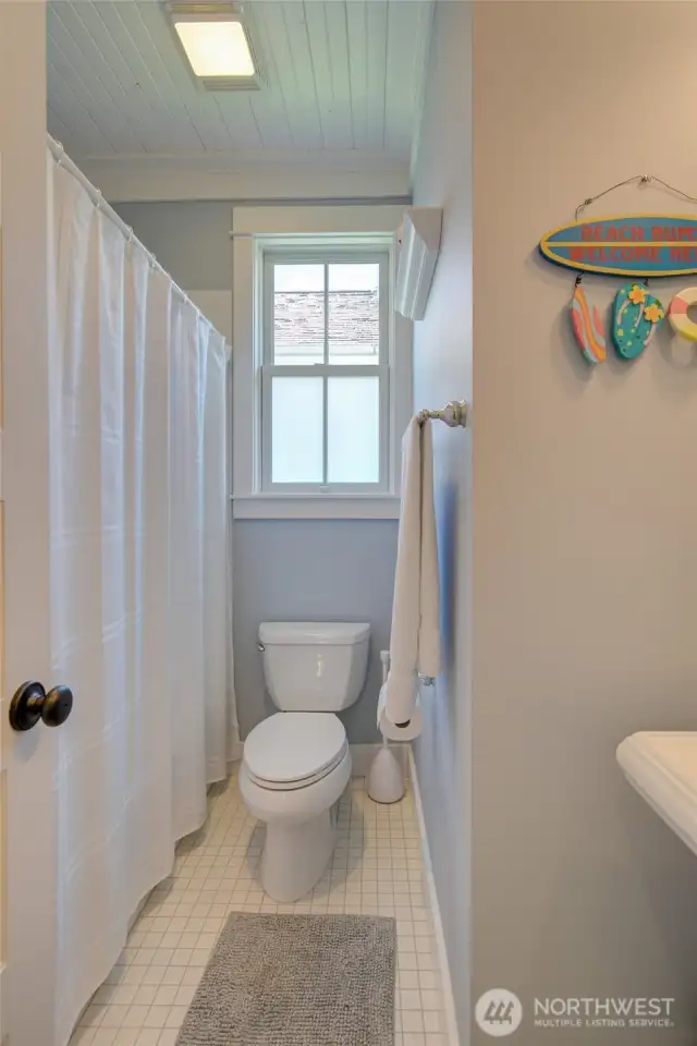 The hall bath with a cast iron tub and subway tile surround.