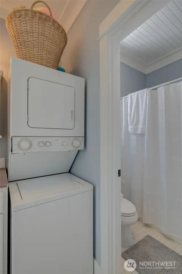 Compact laundry and separate shower area.