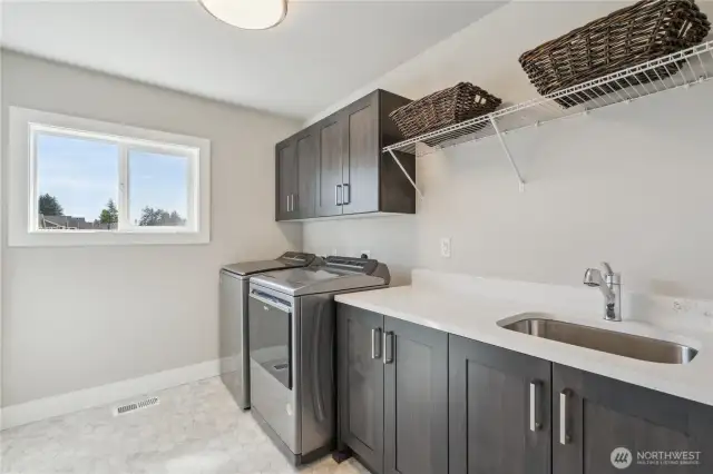 Upper level Laundry room with sink and spacious linen closet