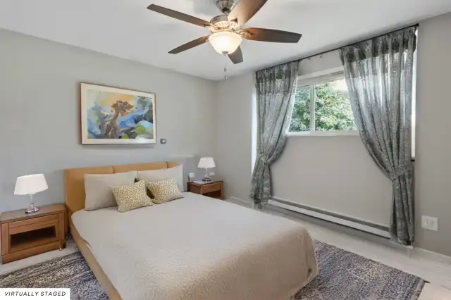 Primary bedroom overlooks the serene and private backyard.