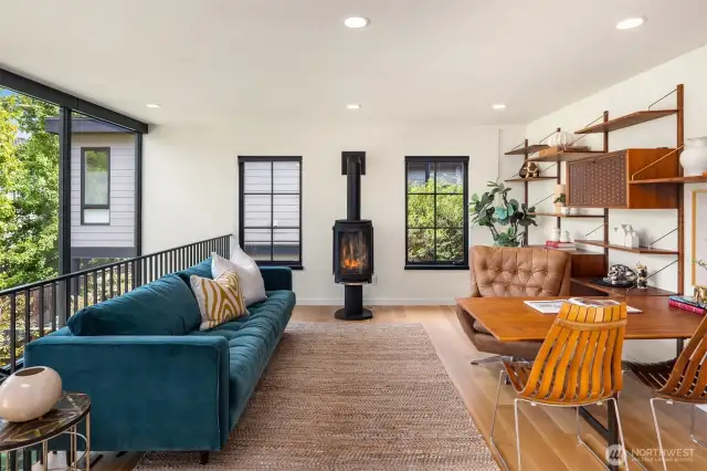 A stylish loft features an original 1950s Danish wall unit by Poul Cadovius and a sculptural Danish fireplace.