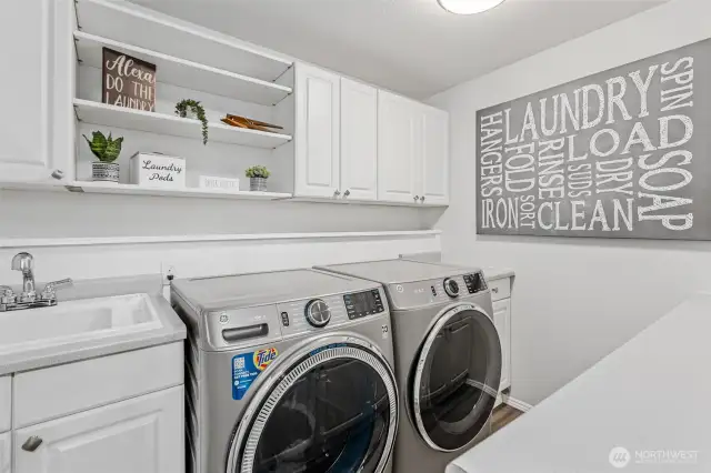Lower level laundry w/ sink, counter & plenty of cabinetry
