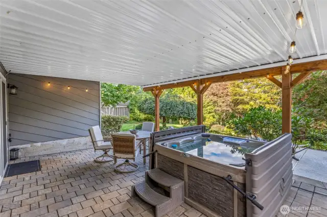 Patio w/ hot tub off lower level.