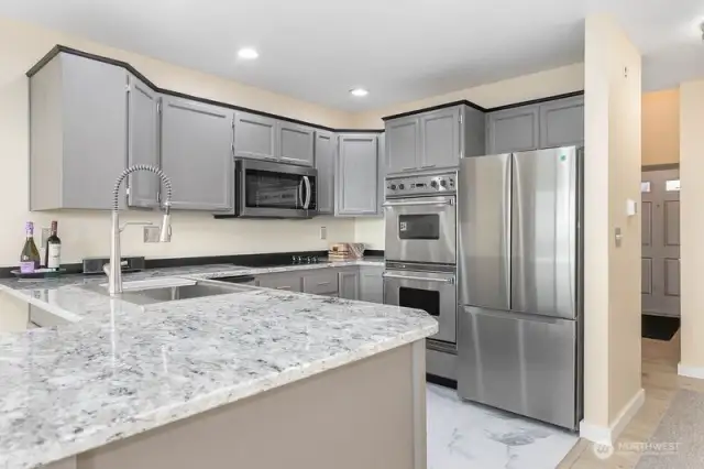 Step into this newly warm and inviting remodeled kitchen, featuring stunning new granite countertops, sleek stainless steel appliances, a brand-new cooktop and a double oven ready for all your gourmet cooking.