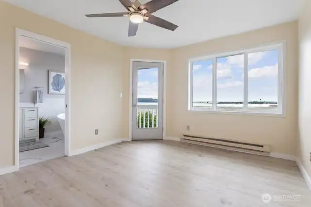 The fully remodeled primary bedroom is fresh, bright, and inviting.  Tastefully designed to start and end your day in comfort. Step outside onto your private deck and enjoy morning coffee, soak in the sun, or enjoy quiet evenings watching the sun set.