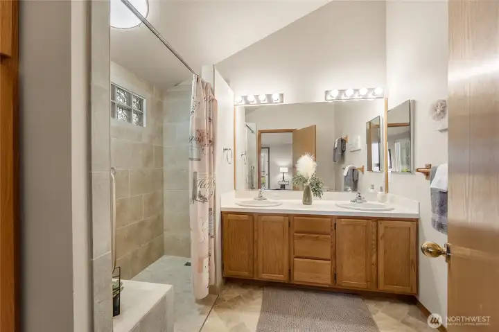 Stylish and refreshing ensuite featuring a double vanity and walk-in tile shower.