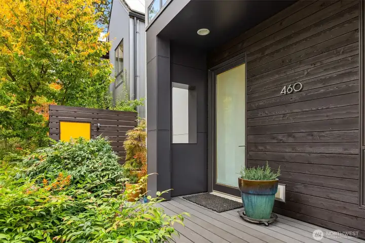 The welcoming covered front entry offers plenty of room for potted plants or a place to sit.