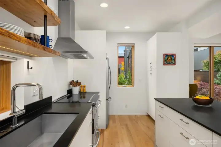 A new (2023) Miele dishwasher is tucked away next to the deep undermount sink.