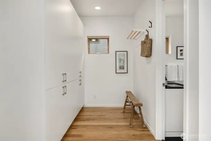 With deep built-in storage, the open dressing room design flows into the primary en suite bathroom.