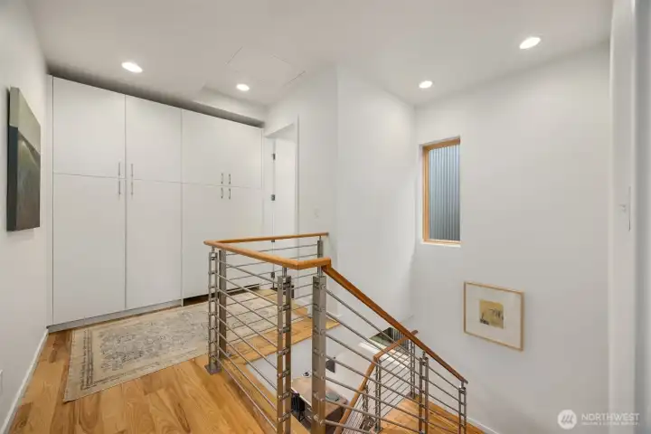 The roomy landing is home to a convenient laundry center with updated Miele washer/dryer and extra storage.