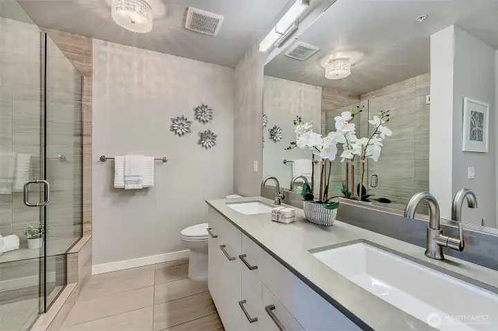 Primary bath, double vanity, loads of storage and walk in shower with bench.