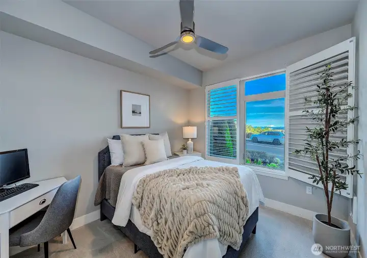 Guest bedroom with shutter open to showcase the breathtaking views.