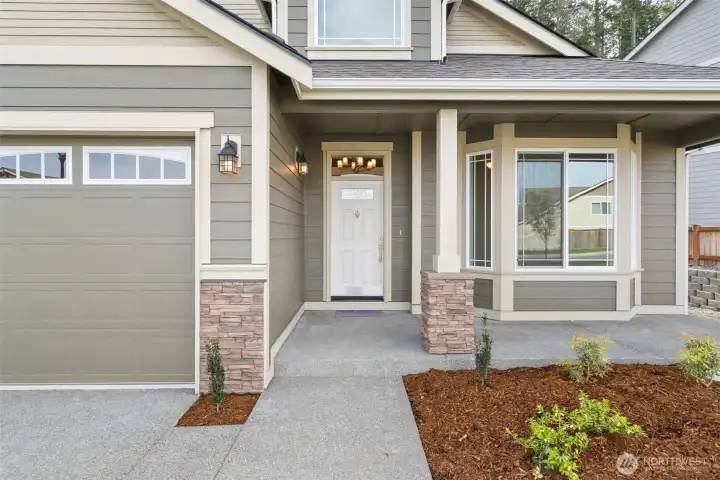 Our Redwood one story floor plan has the perfect covered porch entry with stone accents to welcome you and your guests.
