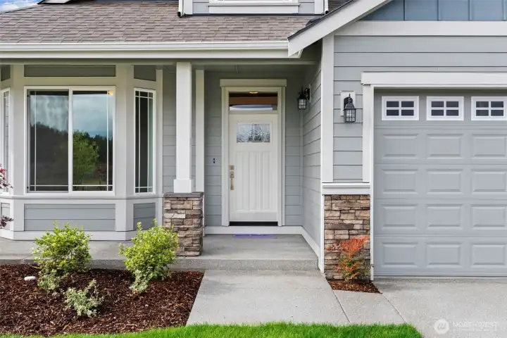 Our Redwood one story floor plan has the perfect covered porch entry with stone accents to welcome you and your guests.