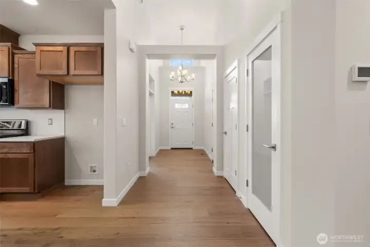 Looking back at entry door. Step into the entry hall with hardwood flooring, contemporary details and white millwork throughout.