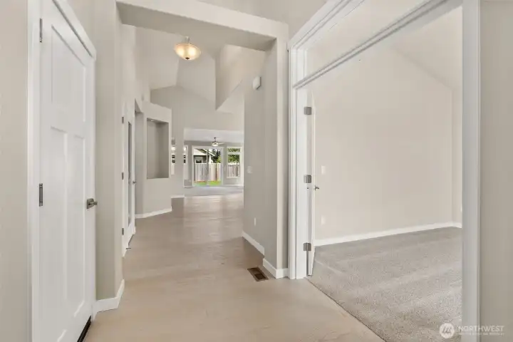Step into the entry hall with hardwood flooring, contemporary details and white millwork throughout. Clear glass door leading to den or third bedroom option.