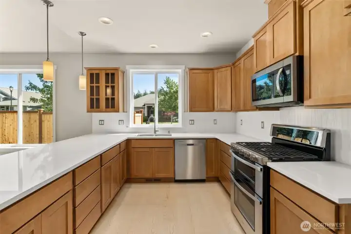 Stainless steel appliances include double oven range, dishwasher and microwave.