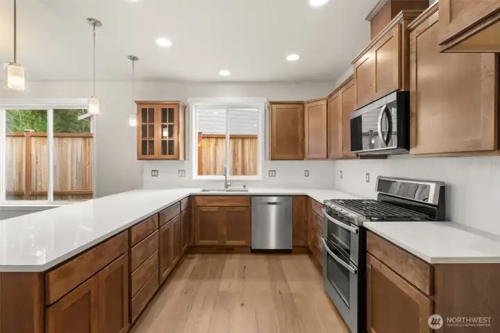 Stainless steel appliances include double oven range, dishwasher and microwave.