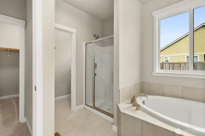 Primary bathroom offers a standard walk-in shower with glass door and a separate, private water closet.