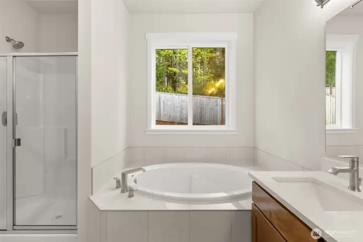 Primary bathroom offers a standard walk-in shower with glass door and a separate, private water closet.