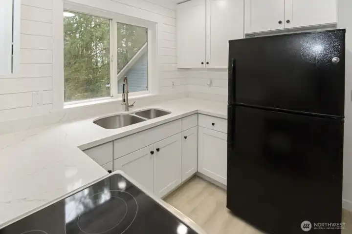 ADU kitchen with quartz counters and beautiful shiplap backsplash